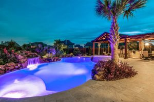 House backyard with pool featuring outdoor kitchen, grilling station, and bar - Jacobus project