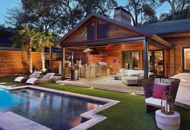 covered patio and outdoor kitchen next to a pool in northern texas