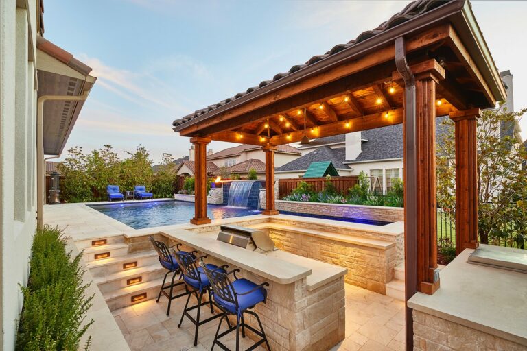 recessed outdoor kitchen next to a pool