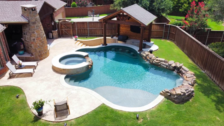 a custom pool and spa with outdoor living area covered by a pergola